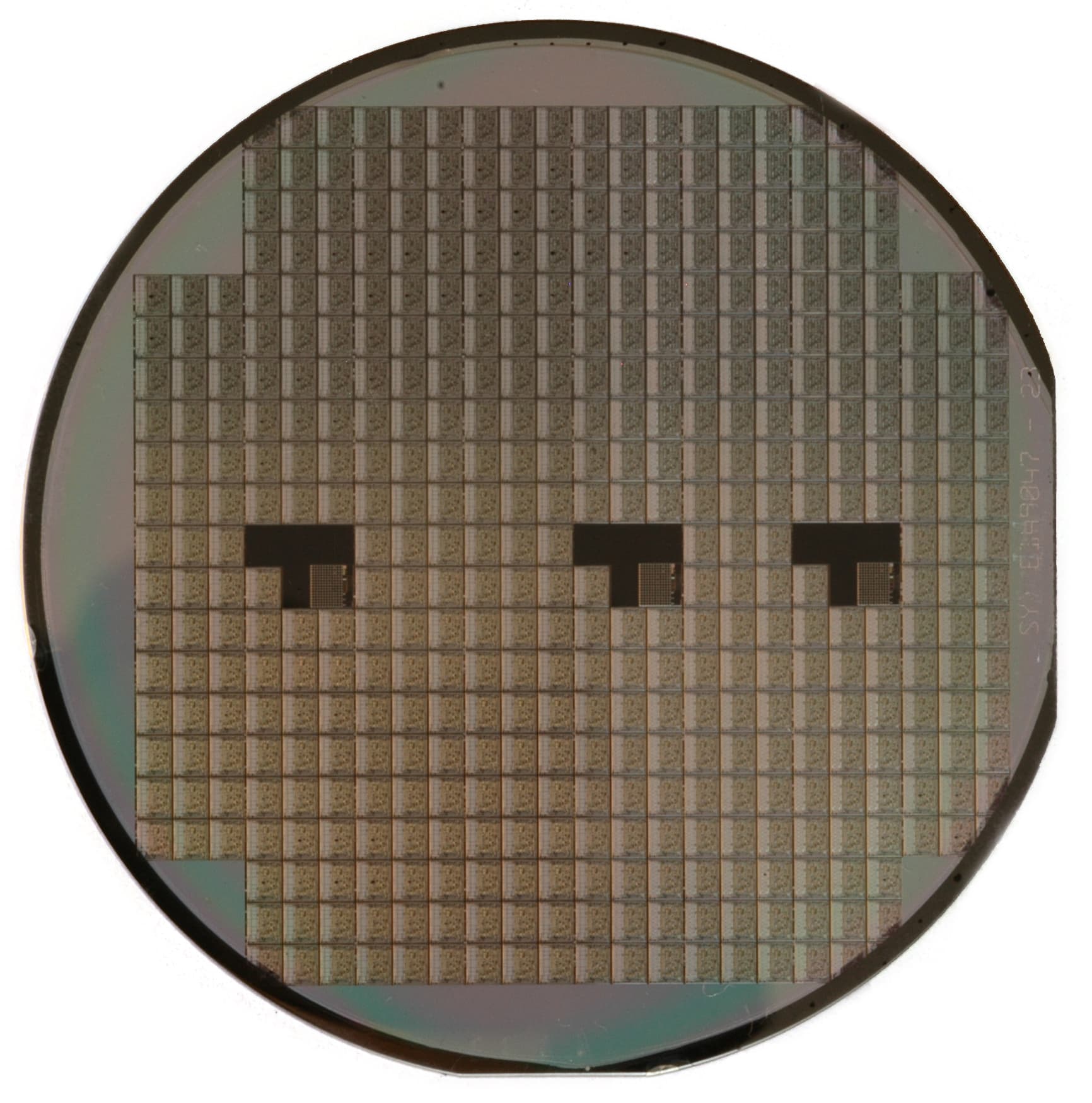 A circular silicon wafer reflecting coloured light